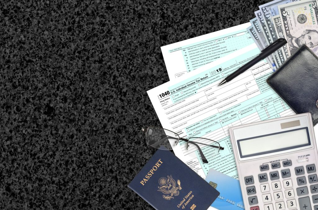 IRS form 1040 Individual income tax return lies on flat lay office table and ready to fill